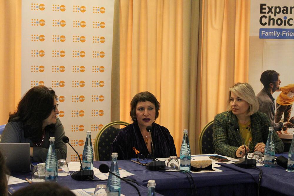 Representatives from UNFPA and the private sector sitting at the discussion table