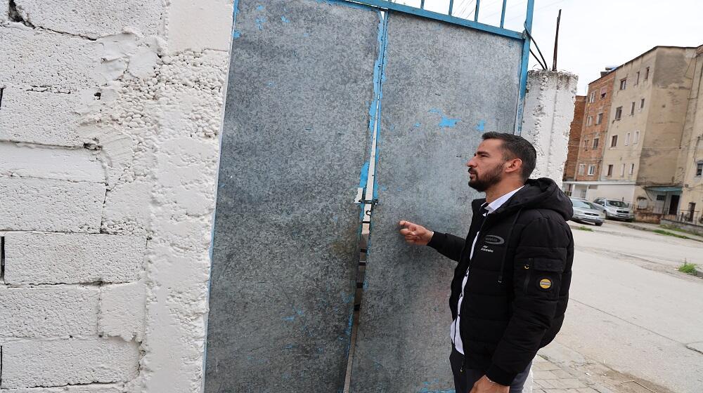 Grisel Zenuni, a 33 year old man, a health mediator knocking on the door of a community family he visits regularly to help. 